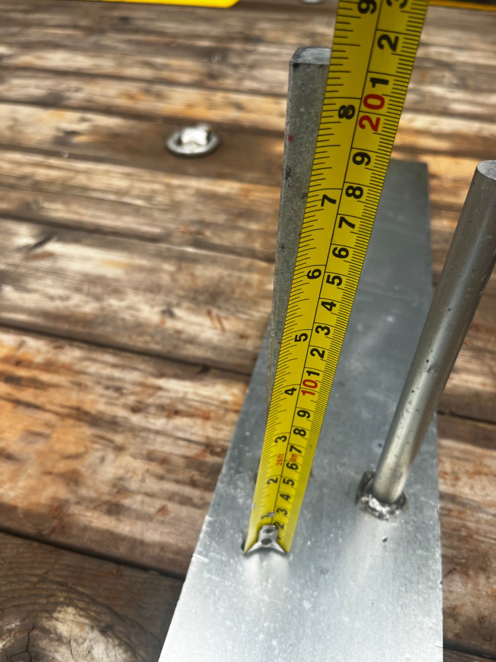 Tape measure beside a solid welded peg showing 8 and a quarter inches of length